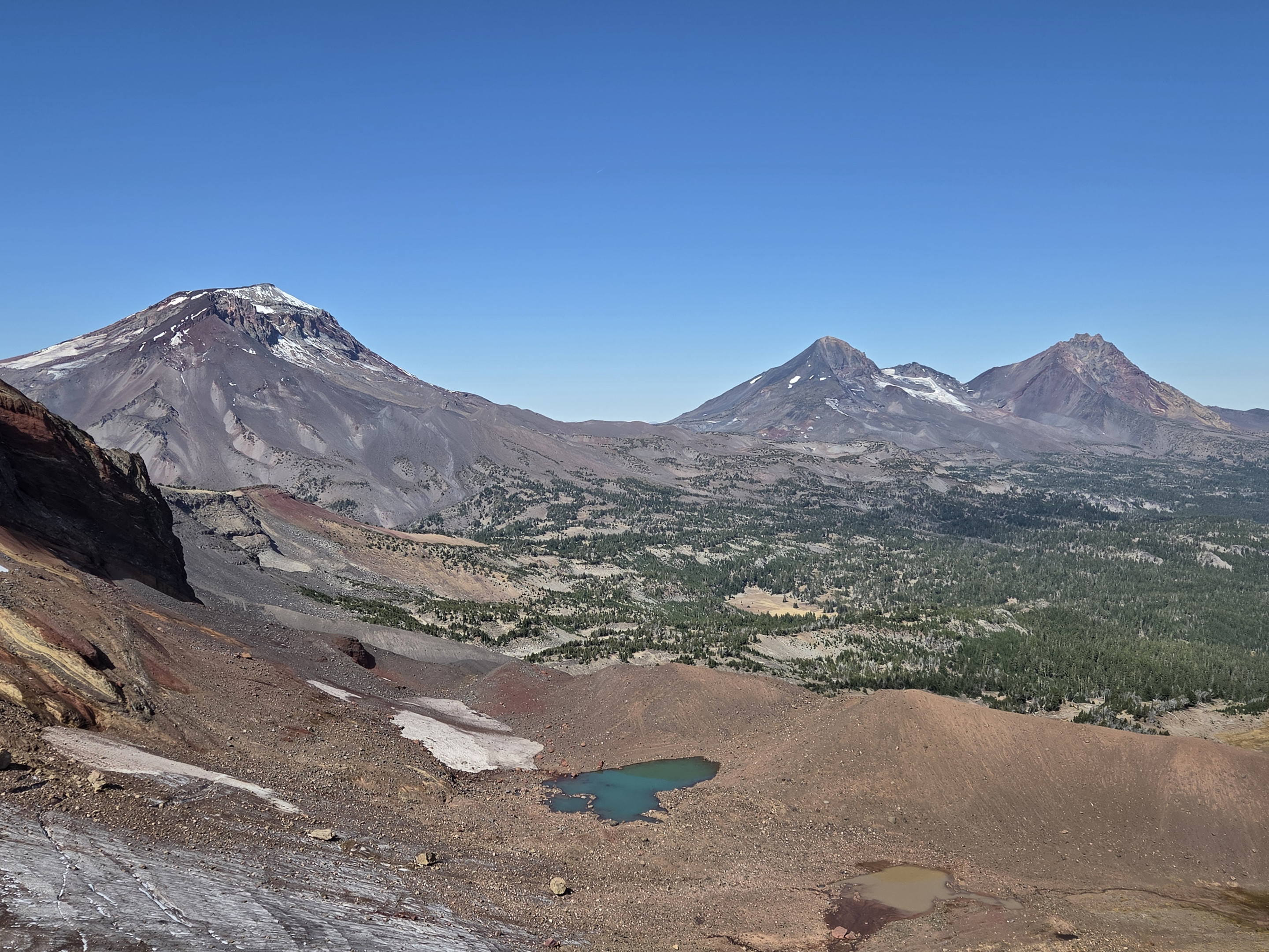 From the overlook, the view extended past the glacial basin to the Three Sisters and distant Cascade peaks.